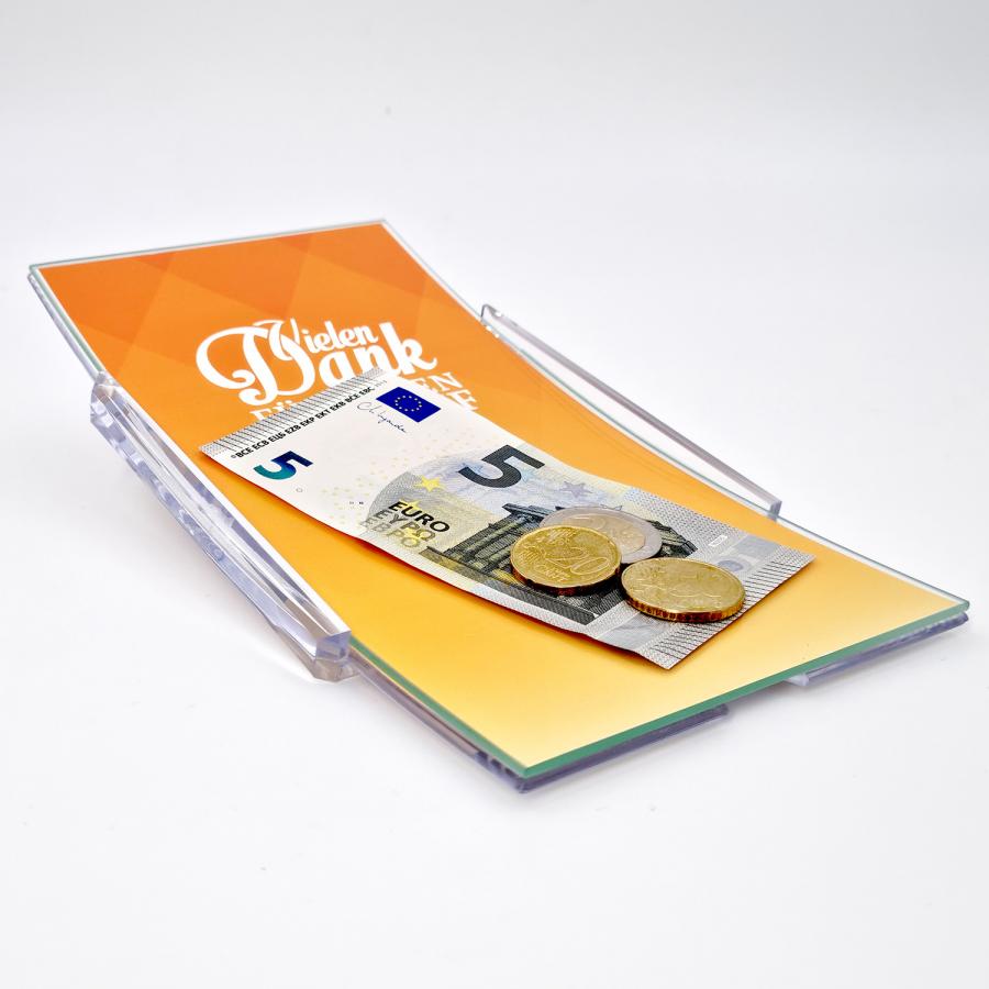 Wechselgeld aus einem Zahlteller mit Glasfläche, gelb bedruckt