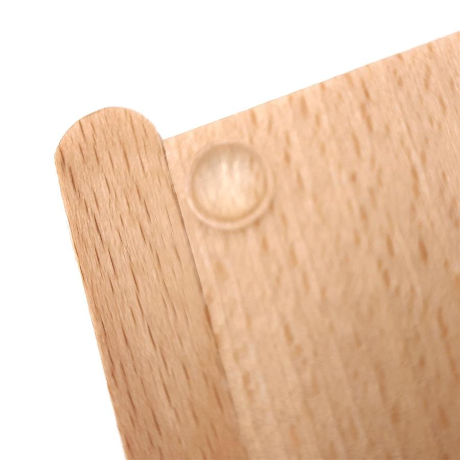 Detailaufnahme des Gummistoppers am Kassierteller aus Holz